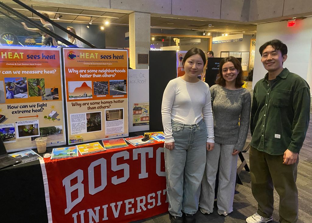 SPH researchers stand with their posters about their work studying heat in Chelsea and East Boston at the Museum of Science